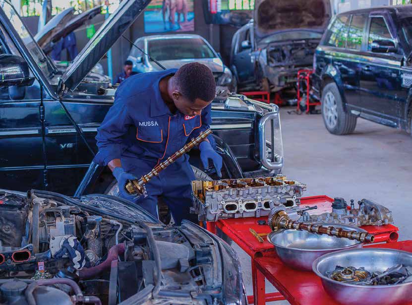 European Car Clinic technician repairing an engine